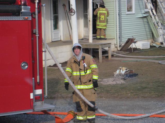 Firefighter Bud Charlton operates Engine 1 at a first due house fire.